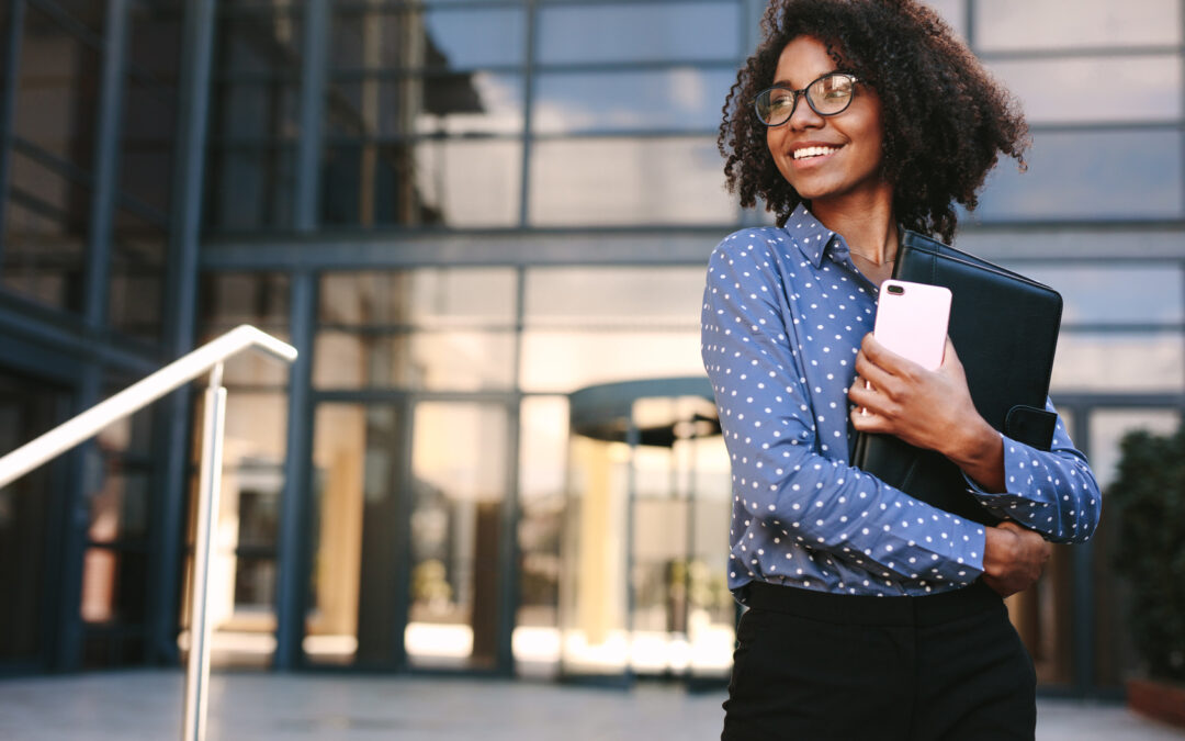 Happy business woman standing outside a office building